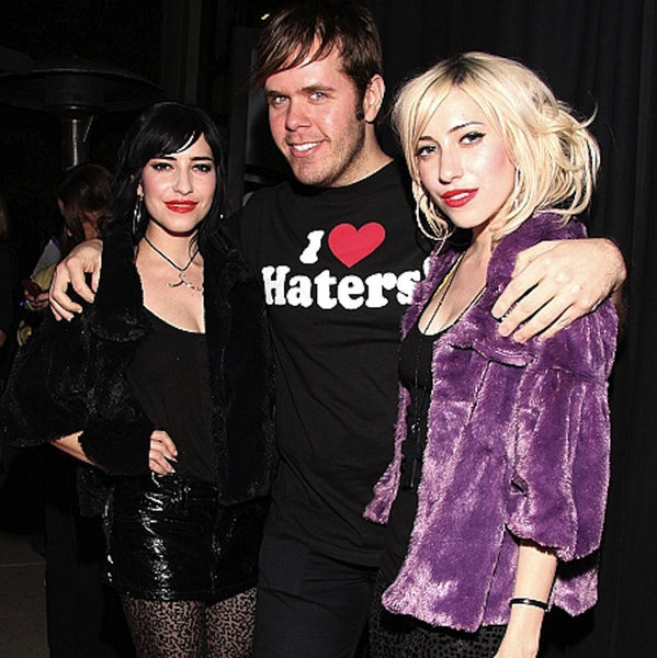 The Veronicas with Perez Hilton.Proudly announce your "hangup" with this beautiful large-scale hanger charm. (Try wearing it with the top resting in the hollow of the neck.) Available in Sterling Silver or Gold Vermeil over Sterling Silver, as shown on this hanger worn by Lisa Origliasso, of The Veronicas. This hanger charm is wonderful worn in the hollow of the collarbone, as a hanger choker necklace and is a great gift for anyone who wears clothes! (And some clothing designers!) Pretty Little Hangup-Sterl