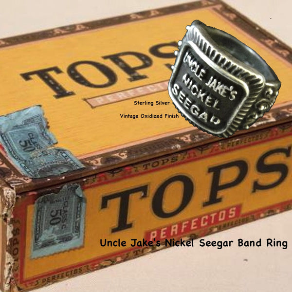 Even if you are not a cigar aficionado, this vintage cigar band ring is "smoking". The first in what will be an expansive and whimsical collection,  this 3D version of an actual antique "Seegar" band--the first of its kind. Sterling Silver in my antique satin oxidized finish to bring the old cigar band to life once again!  Top 1/2" wide approximately.  Made in the USA by hand. Hand signed.  Sterling Silver Uncle Jake's Nickel Seegar Cigar Band Ring.  Be sure to check out my other two cigar band rings--Mild 