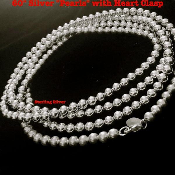 There is a reason these "pearls" are a Fables "Classic". Whether you like Jackie Kennedy or Prince, you should own this extra-long Sterling Silver Pearl necklace with its heart clasp. If you can only take one accessory on any trip, let it be this versatile strand of Silver Pearls.(It is also a perfect gift for a bride!)  A generous 5 feet of 7mm Sterling Silver Pearls with a heart clasp. Hand made in the USA. Hand Signed.