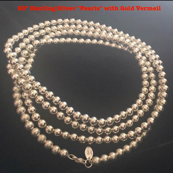 There is a reason these "pearls" are a Fables "Classic". Whether you like Jackie Kennedy or Prince, you should own this extra-long Sterling Silver Pearl necklace with its heart clasp. If you can only take one accessory on any trip, let it be this versatile strand of Silver Pearls.(It is also a perfect gift for a bride!)  A generous 5 feet of 7mm Sterling Silver Pearls with a heart clasp. Hand made in the USA. Hand Signed.