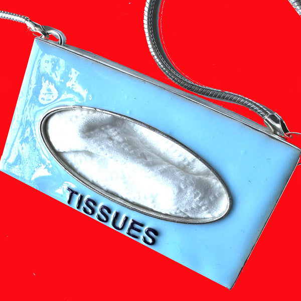 Got a tissue hanging" around? You do if you are wearing this POP ART Sterling silver Hand-Enameled Baby  Blue Tissue Box necklace!  Nothing to sneeze at!  But maybe something to sneeze WITH! Stick an actual tissue inside and pop it through the opening for fun! (Comes with small pack of travel tissues!)  Baby Blue Sterling Silver Tissue Box with Aubergine letters "Tissues" is approximately 1-3/8" x 1-1/4" x 3/8" with Sterling SilverSnake Chain attached.  