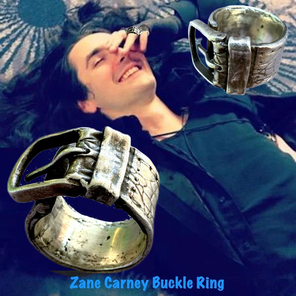 Substantial piece of pure vintage rock and roll--as seen on Zane Carney, in Avril Lavigne's "I Fell in Love with the Devil"Music Video.. Opulent,finely detailed band of timeless whimsy in Oxidized Sterling Silver Buckle Ring makes a statement alone or as part of a collection of fables...Sterling Silver distressed Crocodile textured buckle ring. Handmade in America and Hand-signed.