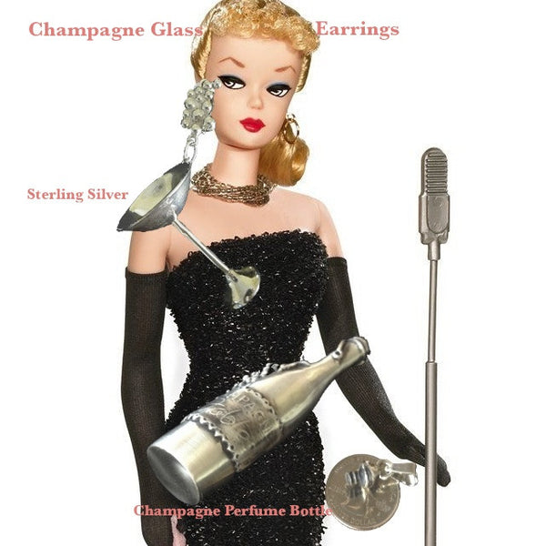 Barbie Doll with Fablesintheair.com Champagne Perfume Bottle Charm.When this cork pops...out wafts the smell of your favorite perfume, or aromatic oil... Fables Champagne... any imaginable scent..in an elegant sterling silver magnum. Fill with your favorite scent or oil. Puts you in the celebratory mood.  3-2/16" x 1-1/2" Approximately.  Sterling Silver Fables Champagne Perfume Bottle Charm. Comes on a sterling silver chain.