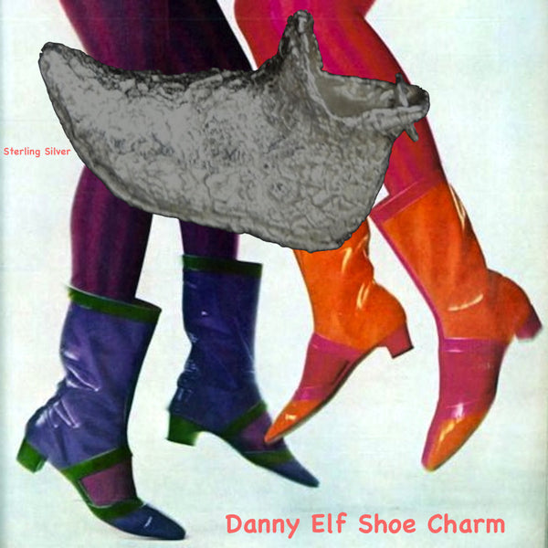 On a background of 1960s MOD red and purple patent boots and tights.This textured Elf Slipper Shoe is enough to make your toes curl! Straight from "I Dream of Jeannie", (and The North Pole!) this whimsical large charm has beautiful lines and nearly resembles the magic lamp, itself! Even if the shoe doesn't fit...you can still wear it! Equally fun as a single charm on a bracelet as it is around your neck! Sterling silver textured elf shoe 3D charm with turned up toe...a truly magical charm and comes with a b