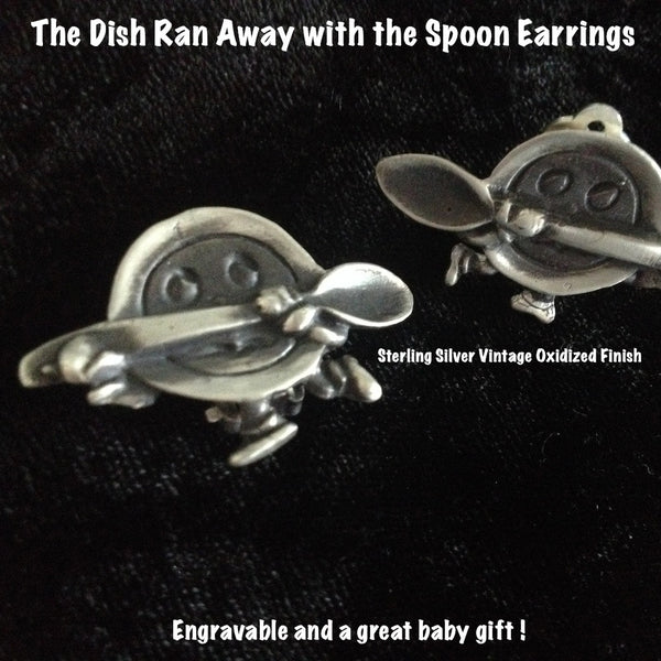 You know the drill. It started with the mouse and, well...if you were a dish and a spoon, wouldn't YOU run away if you heard a dog laughing? Seriously. A mirrored pair of adorable earrings. Also available in pin which makes a perfect baby gift. (for the mother first, with name engraved on spoon handle!)  1-1/2" by 3/4" approximately. Hand made in the USA. Hand signed.  Sterling Silver Earrings of The Dish Ran Away with the Spoon-a right and a left. In either Sterling Silver clipbacks or pierced.