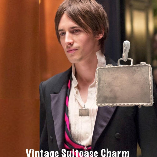 Sterling Silver Vintage Suitcase Charm is a hinged suitcase in which you can tuck an affirmation or scented cotton ball. Shown here on Reeve Carney.