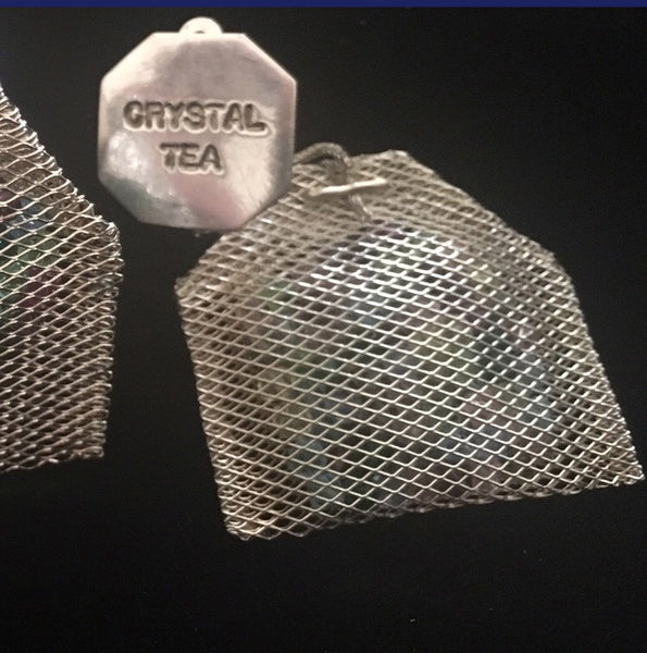 Sterling Silver mesh teabags filled with Austrian Crystals, hanging by a sterling silver foxtail "thread" from a Sterling Silver "Paper" "Crystal Tea" tag.3" x 1-5/8" approximately  Handmade in the USA. Hand Signed