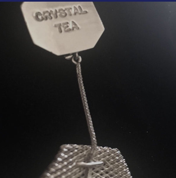 Sterling Silver mesh teabags filled with Austrian Crystals, hanging by a sterling silver foxtail "thread" from a Sterling Silver "Paper" "Crystal Tea" tag.3" x 1-5/8" approximately  Handmade in the USA. Hand Signed